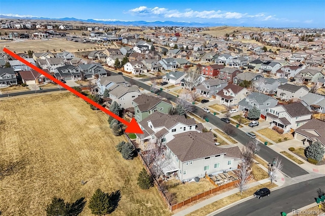 drone / aerial view featuring a residential view and a mountain view