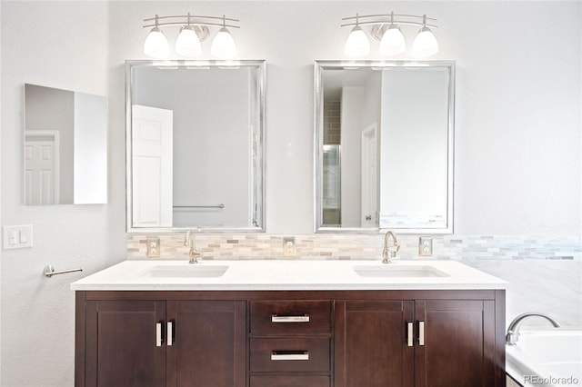 full bathroom with double vanity, tasteful backsplash, and a sink