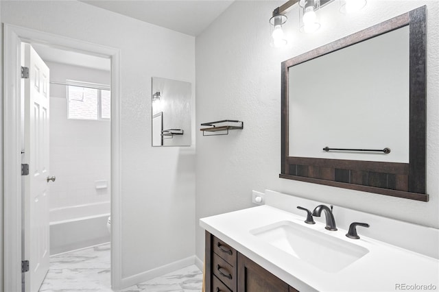 full bathroom featuring marble finish floor, baseboards, shower / washtub combination, and vanity