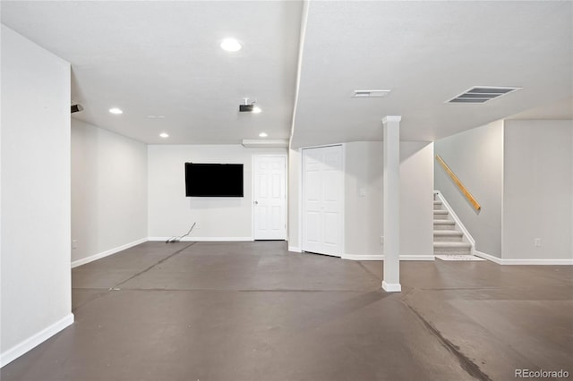 finished basement featuring recessed lighting, visible vents, baseboards, and stairs