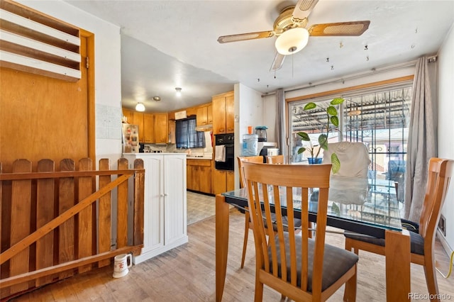 dining area featuring light hardwood / wood-style floors and ceiling fan