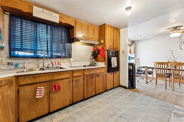 kitchen featuring tasteful backsplash, ceiling fan, sink, and black appliances