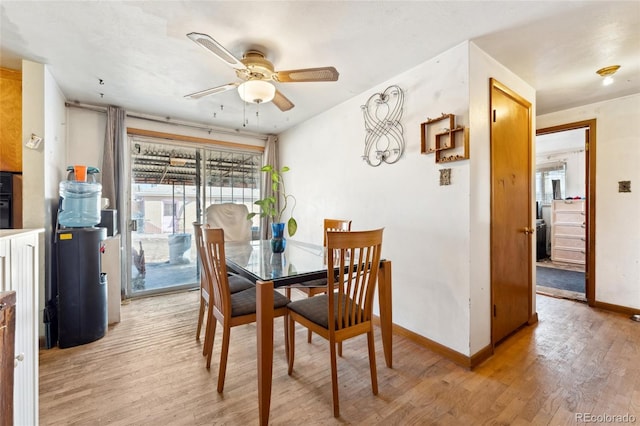 dining space with light hardwood / wood-style flooring and ceiling fan