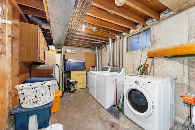 clothes washing area with washer and clothes dryer