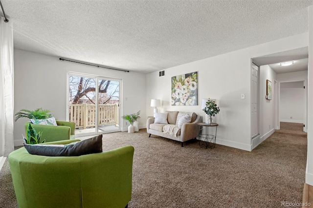 carpeted living area with visible vents, baseboards, and a textured ceiling