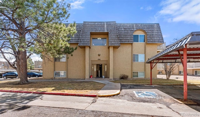 view of property featuring uncovered parking