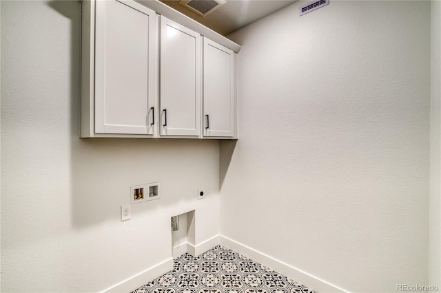 washroom with electric dryer hookup, visible vents, cabinet space, baseboards, and hookup for a washing machine