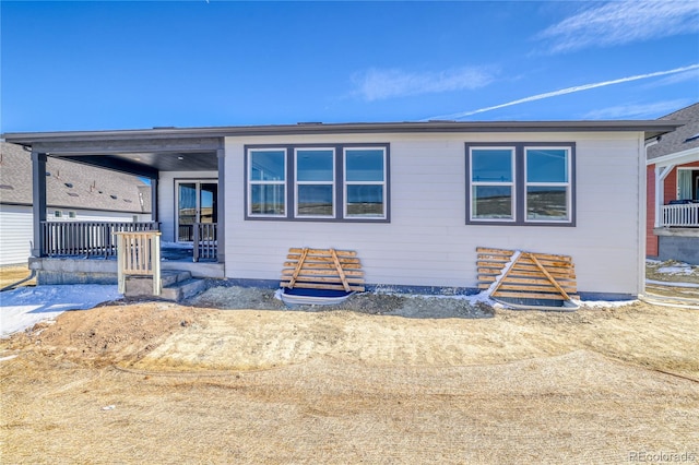 view of front of property with a porch and central AC