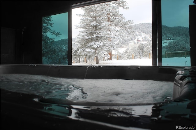 details with a hot tub and a mountain view