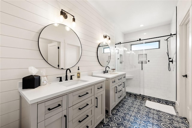 bathroom with tile patterned flooring, vanity, and a shower with door