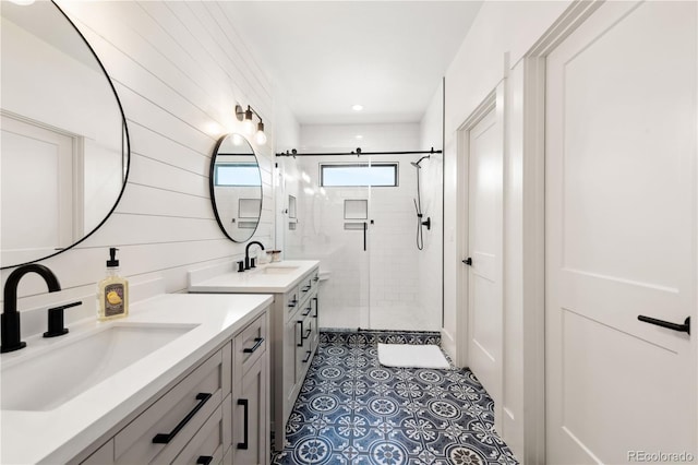 bathroom featuring vanity, a shower with shower door, and tile patterned floors