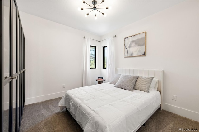 carpeted bedroom with a notable chandelier