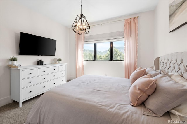 carpeted bedroom with a chandelier