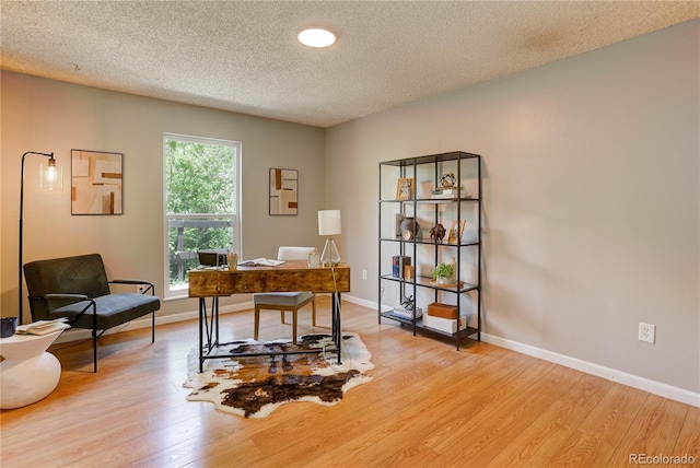 3550 S Harlan St Unit 259, Denver, CO 80235 - home office with light wood-style floors, a textured ceiling, and baseboards