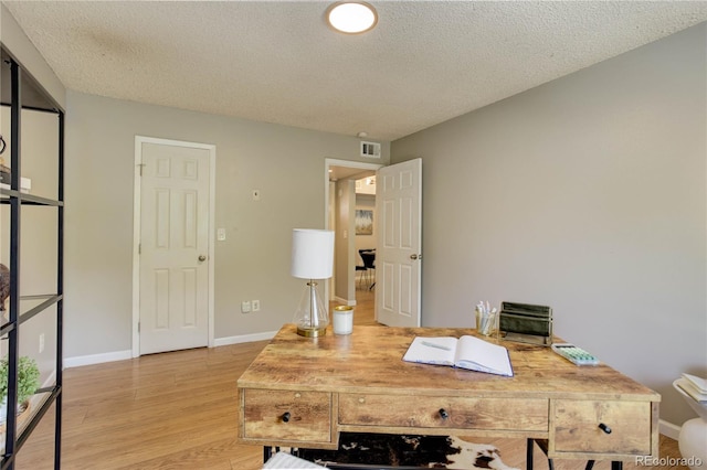 3550 S Harlan St Unit 259, Denver, CO 80235 - office space featuring light wood finished floors, a textured ceiling, and baseboards