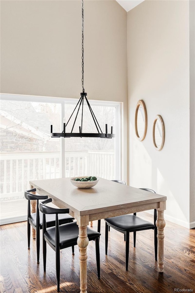 dining area featuring a healthy amount of sunlight, breakfast area, and wood finished floors