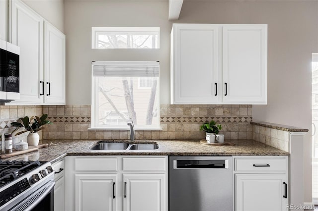 kitchen with white cabinetry, appliances with stainless steel finishes, and a sink