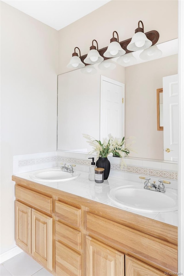 bathroom with double vanity, tile patterned flooring, and a sink