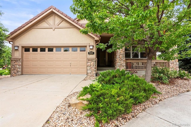 6542 S Tempe St, Aurora, CO 80016 - view of front facade with concrete driveway, stone siding, stucco siding, and a garage