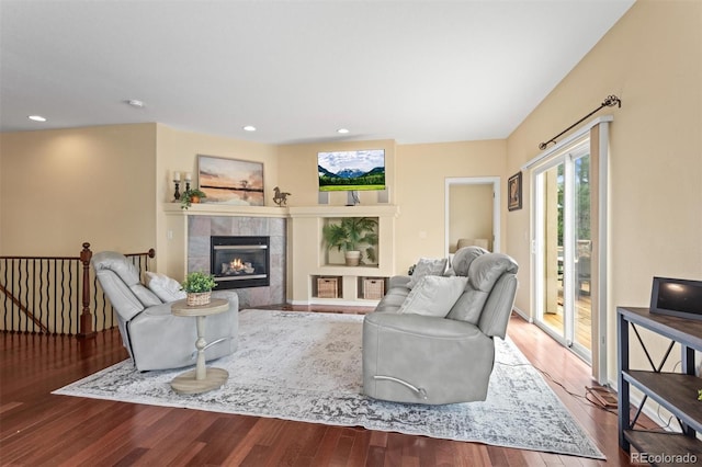 6542 S Tempe St, Aurora, CO 80016 - living room featuring wood finished floors, a tiled fireplace, and recessed lighting