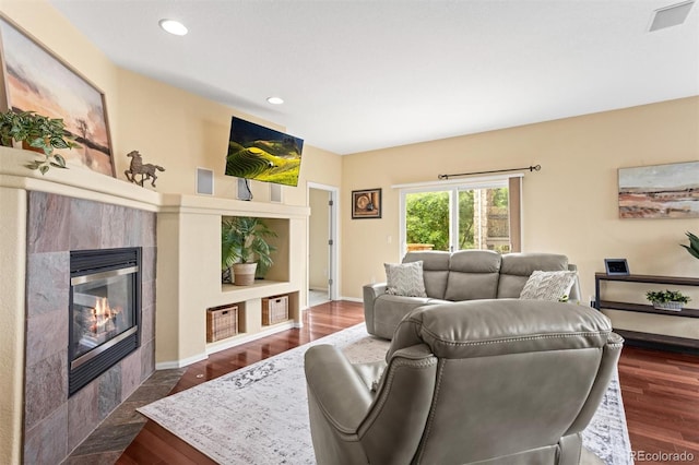 6542 S Tempe St, Aurora, CO 80016 - living room with a tile fireplace, recessed lighting, and dark wood-style floors