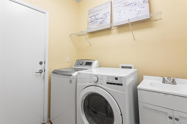 6542 S Tempe St, Aurora, CO 80016 - washroom featuring washing machine and dryer and cabinet space