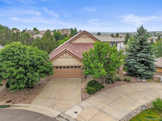 6542 S Tempe St, Aurora, CO 80016 - view of front facade featuring driveway, stucco siding, and an attached garage