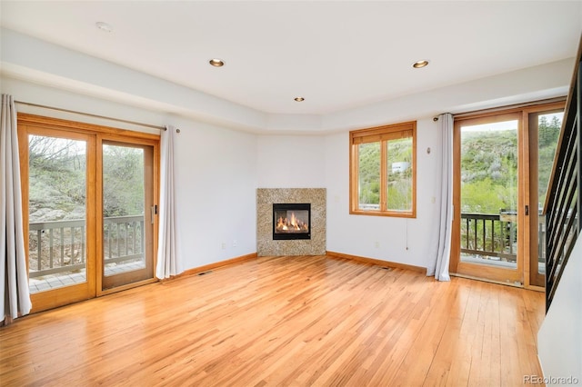 101 Lions Ln, Minturn, CO 81645 - unfurnished living room featuring light wood-type flooring, baseboards, a glass covered fireplace, and recessed lighting