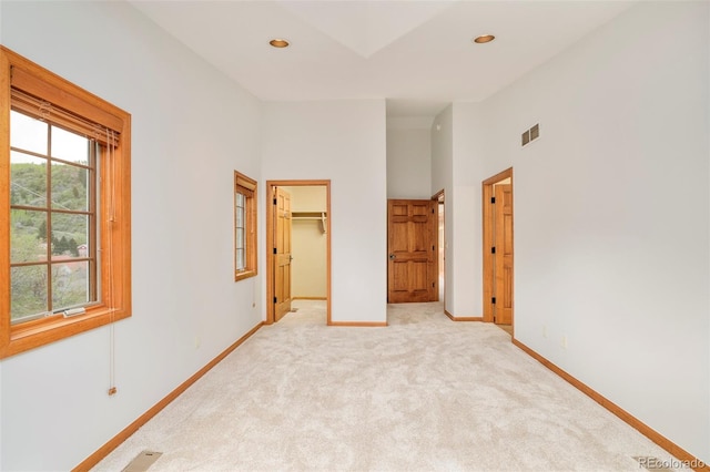 101 Lions Ln, Minturn, CO 81645 - unfurnished bedroom featuring baseboards, light carpet, a spacious closet, a high ceiling, and recessed lighting