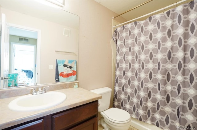 bathroom with vanity, curtained shower, and toilet