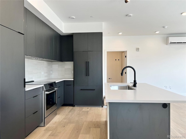 1601 Park Ave Unit 201, Denver, CO 80218 - kitchen with stainless steel electric range, modern cabinets, light wood-style floors, gray cabinetry, and recessed lighting