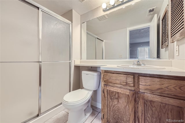 bathroom with a textured ceiling, vanity, toilet, and an enclosed shower