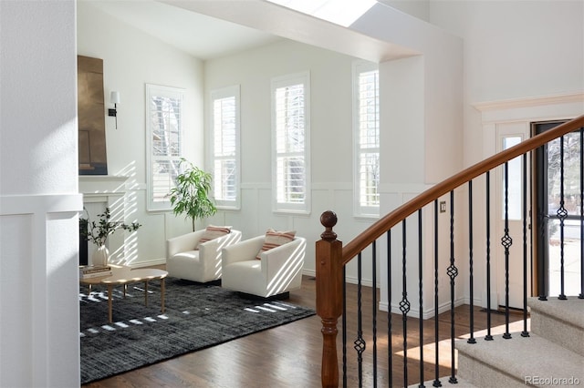 living area featuring hardwood / wood-style flooring and vaulted ceiling