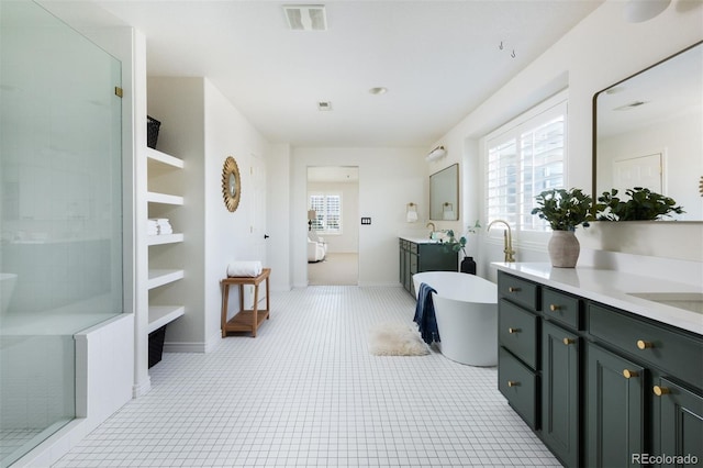 bathroom with shower with separate bathtub, plenty of natural light, tile patterned flooring, and vanity