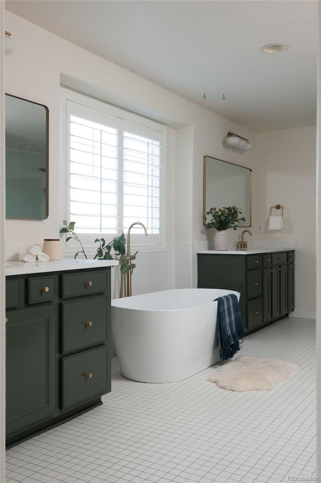 bathroom with tile walls, vanity, tile patterned flooring, and a bathtub