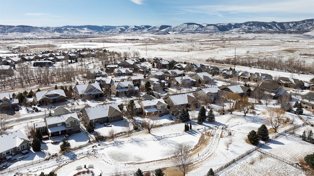 snowy aerial view with a mountain view