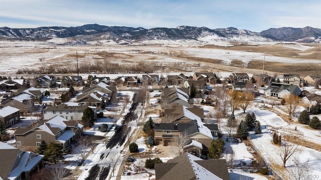 snowy aerial view featuring a mountain view