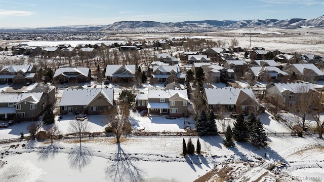 snowy aerial view with a mountain view