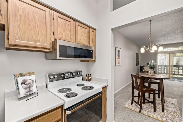 kitchen with carpet floors, white electric stove, light countertops, stainless steel microwave, and a chandelier