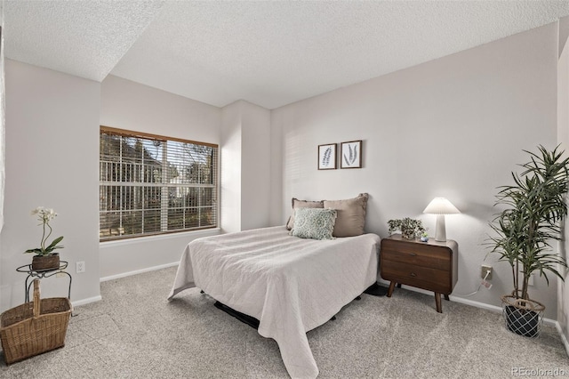 carpeted bedroom with baseboards and a textured ceiling