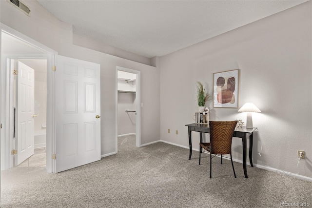 office featuring visible vents, carpet flooring, and baseboards