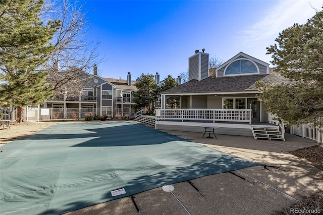 view of swimming pool featuring a patio and fence