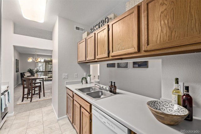 7481 Singing Hills Dr, Boulder, CO 80301 - kitchen featuring dishwasher, a sink, light countertops, a textured wall, and a chandelier
