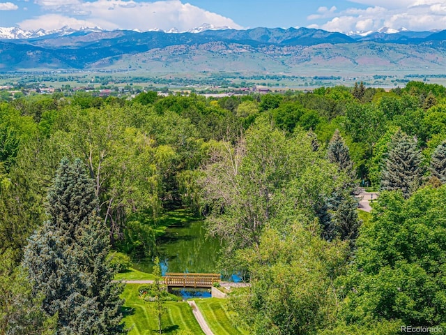 7481 Singing Hills Dr, Boulder, CO 80301 - drone / aerial view of a forest and a mountain backdrop