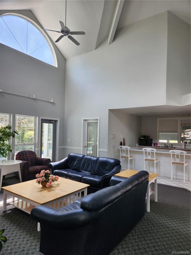 7481 Singing Hills Dr, Boulder, CO 80301 - carpeted living area with high vaulted ceiling, ceiling fan, and plenty of natural light