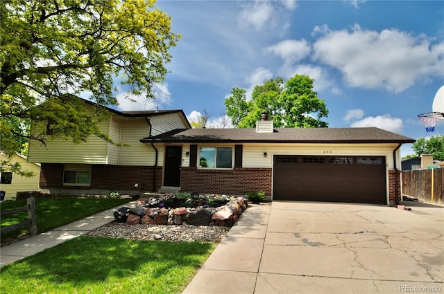 280 Jupiter Dr, Lone Tree, CO 80124 - tri-level home with an attached garage, brick siding, concrete driveway, and a chimney
