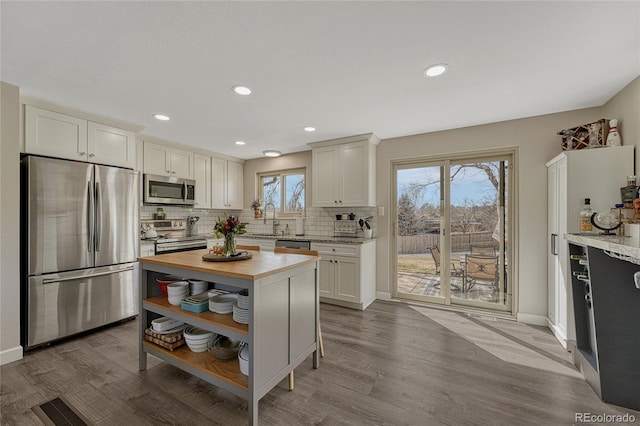 280 Jupiter Dr, Lone Tree, CO 80124 - kitchen with stainless steel appliances, open shelves, decorative backsplash, wood finished floors, and a sink