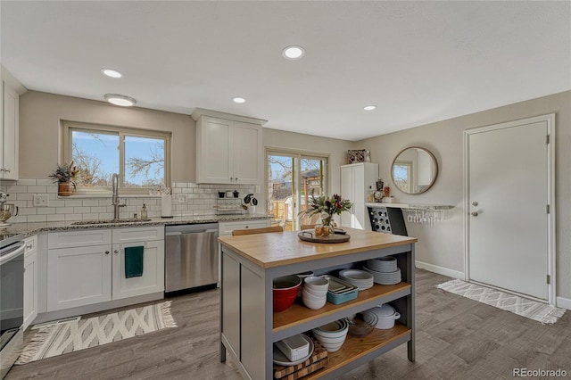 280 Jupiter Dr, Lone Tree, CO 80124 - kitchen with stainless steel appliances, a sink, open shelves, butcher block counters, and tasteful backsplash