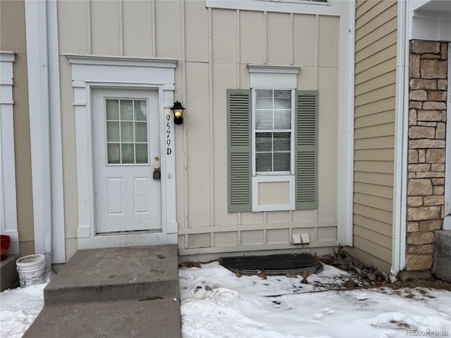 view of snow covered property entrance