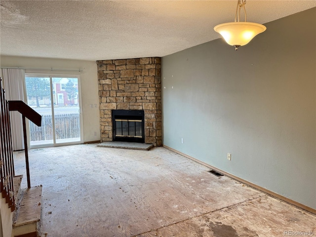 unfurnished living room featuring a textured ceiling and a fireplace